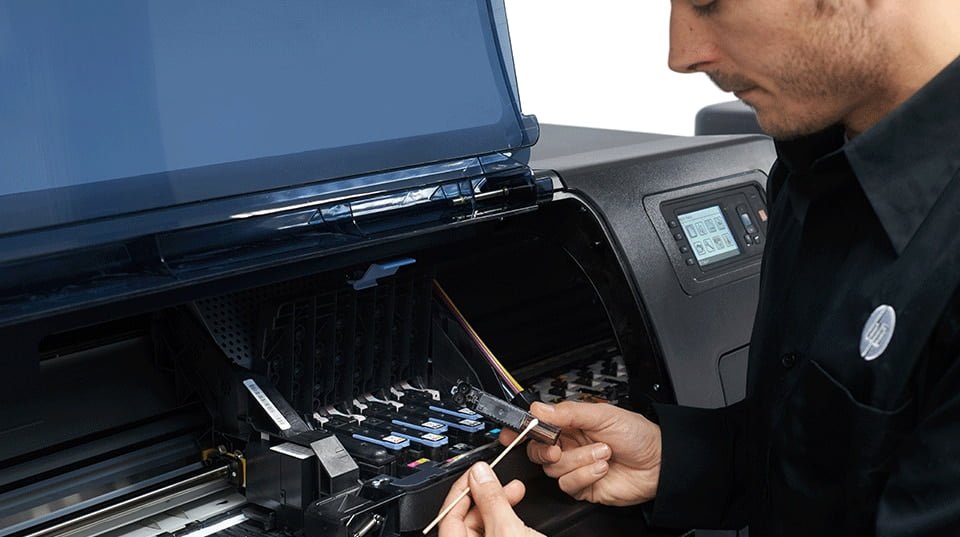 Technician HP printer servicing a large format printer.